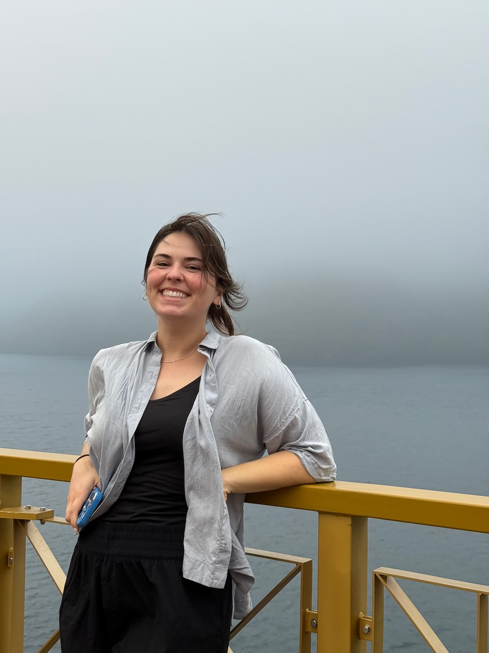Haley smiling on a ferry deck with the water behind her.
